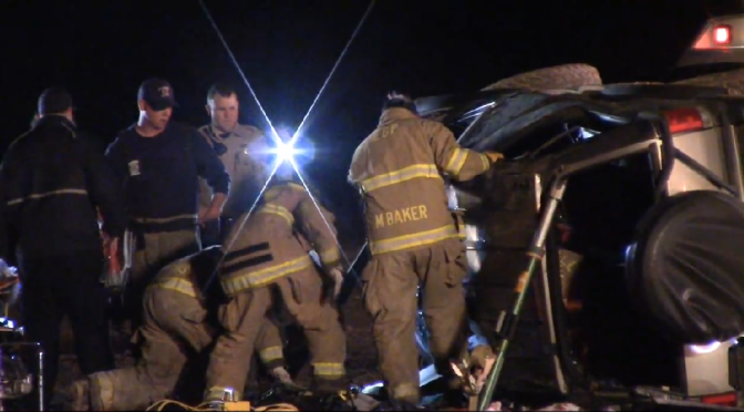 Rescue crews extricate passenger from rolled over SUV